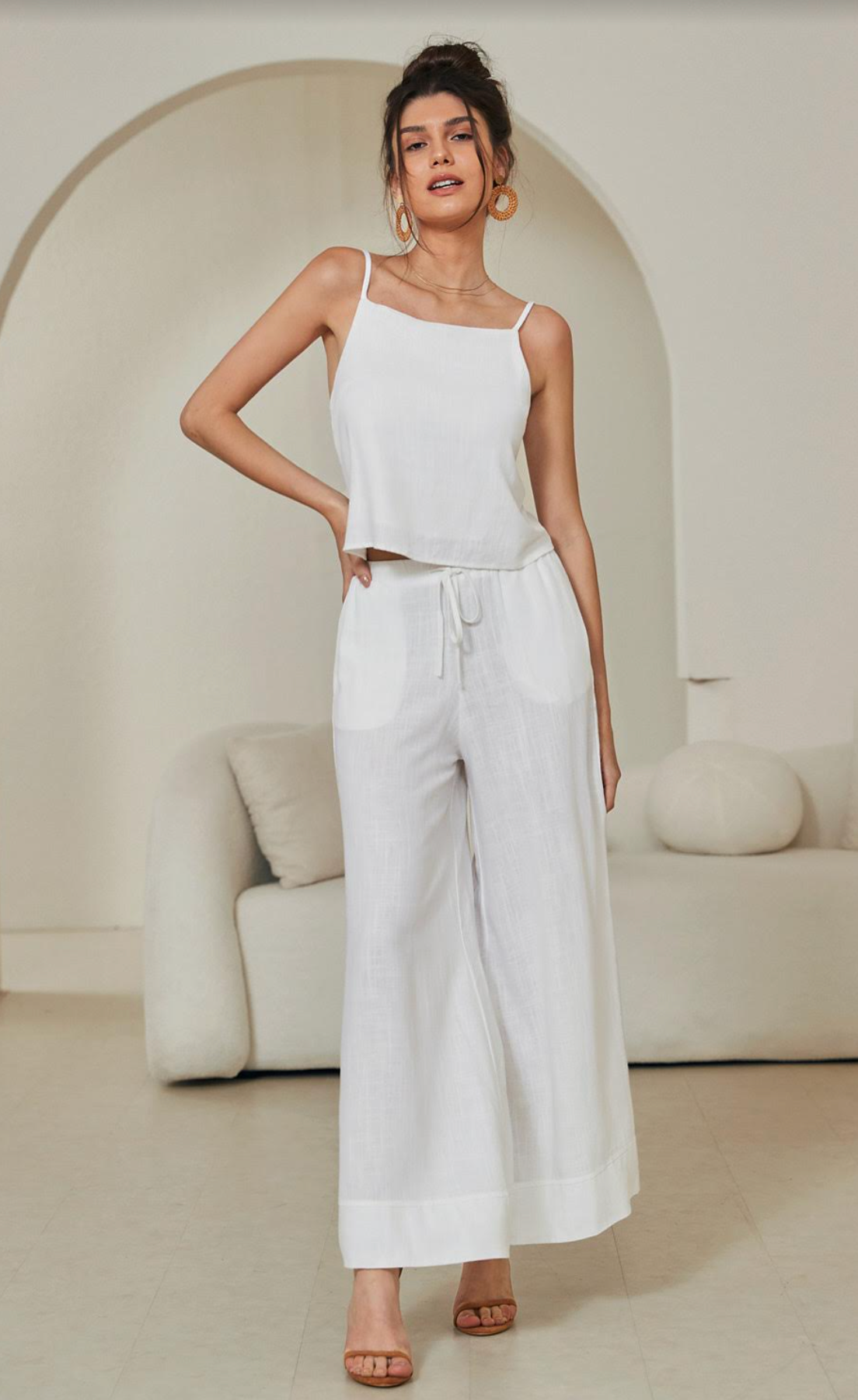 Discover effortless luxury with the Tara Linen Crop Top. Boasting gold-plated details, a tie-up back, a cropped length, and delicate spaghetti straps, this sophisticated piece is both timeless and eye-catching. The lined design ensures a comfortable fit, perfect for any special occasion.