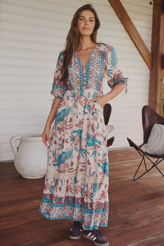 Get ready to rock out in style with our Molli Maxi dress. The symphony print adds a touch of whimsy while the button detail and pockets provide functionality. With an elasticised waist and 3/4 sleeves, this dress is both comfortable and chic. Who says fashion can't be practical?!