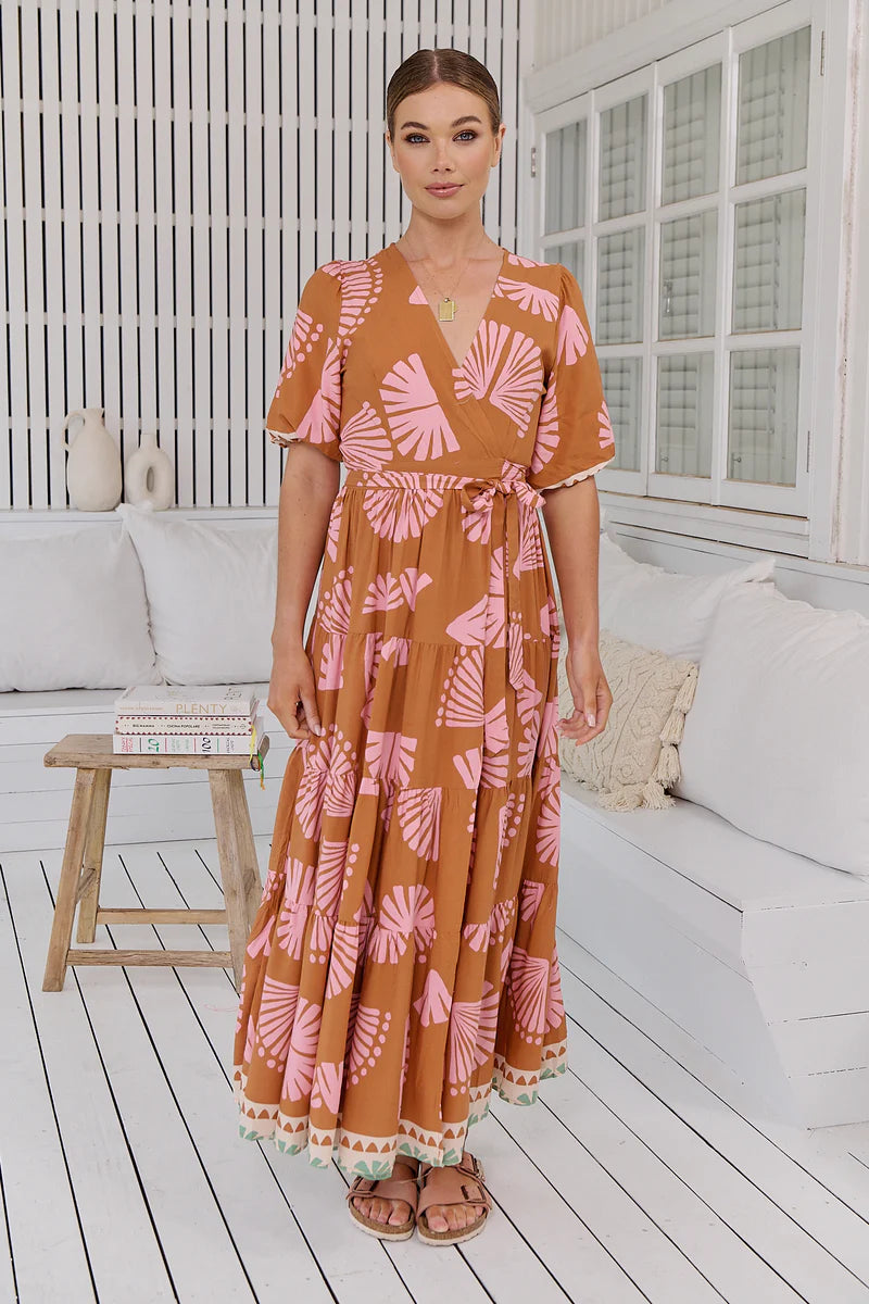 Introducing the Maddi Wrap Dress, a boho dream come true. This maxi dress embodies effortless elegance with its flattering V-neckline, wrap front and tie closure, and mid-length sleeves. Its full-length design effortlessly flows, making it the perfect choice for a chic and carefree look.