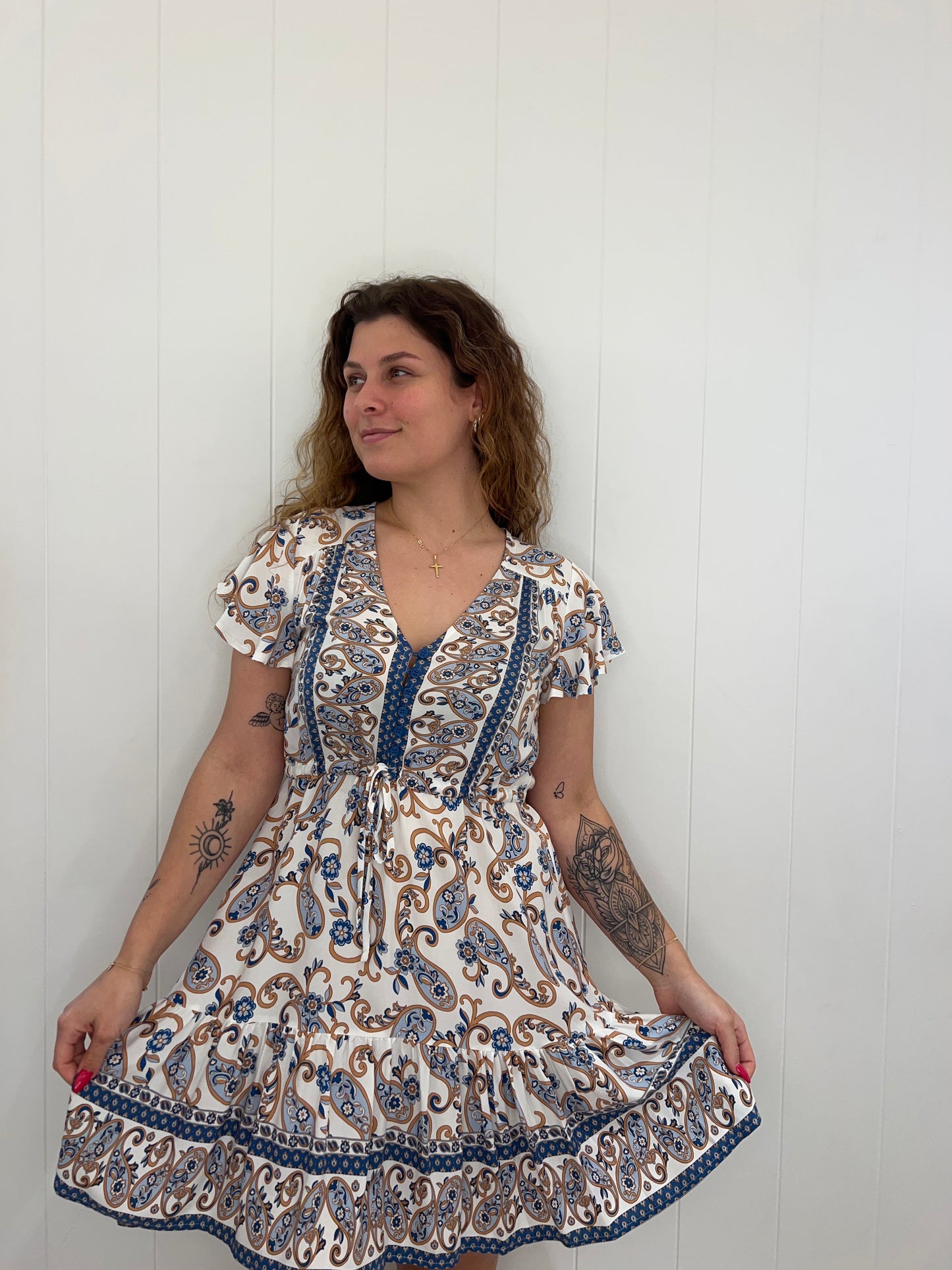 The Callie Mini Dress radiates effortless style with its bell sleeves, drawstring waist, and button detail. Crafted with luxurious details, its flattering V neckline adds a sophisticated touch. Timeless and classic, this mini dress is perfect for any occasion.