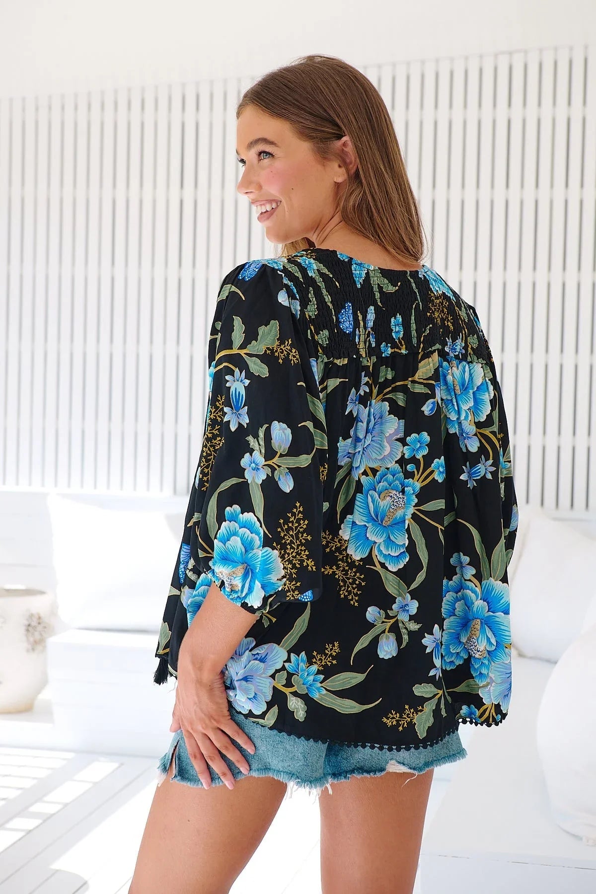 Introducing the Rue Top - Midnight Sapphire, a playful twist on a classic blouse. With its long, draped length and mid-sleeves with cuffs, this top is both elegant and quirky. The tassel strings and v-neck add a fun element to this otherwise sophisticated piece.