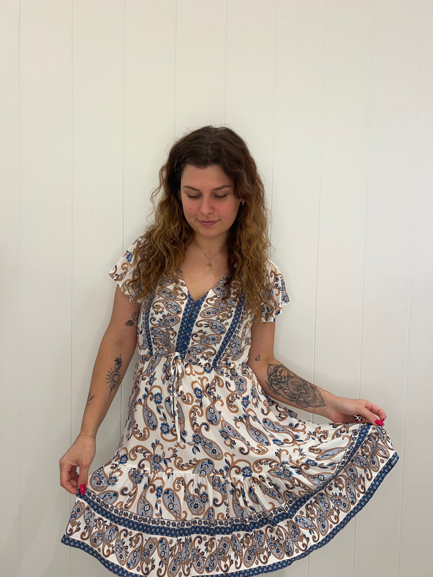 The Callie Mini Dress radiates effortless style with its bell sleeves, drawstring waist, and button detail. Crafted with luxurious details, its flattering V neckline adds a sophisticated touch. Timeless and classic, this mini dress is perfect for any occasion.