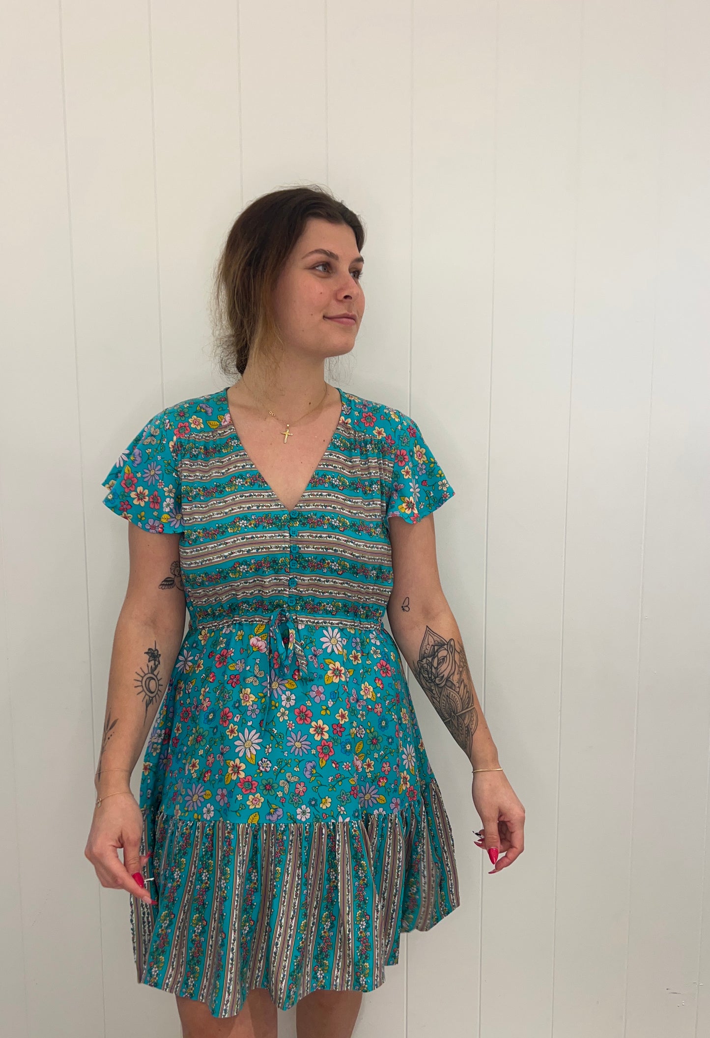 Inspired by luxury, this exquisite Kimia Mini Dress brings timeless style with its V-neck design, delicate button detailing, cinchable drawstring waist, and romantic bell sleeves. Step out in refined sophistication in this beautiful mini dress.