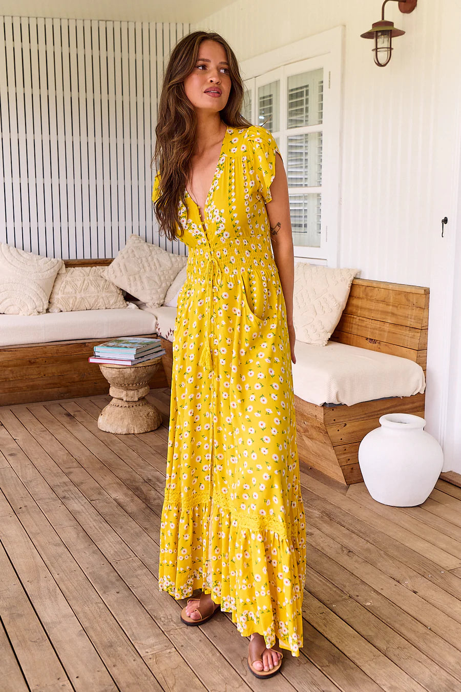 Enjoy sunshine days even more in the Romi Maxi Dress. Crafted from luxuriously smooth fabric, this elegant dress features 3/4 length sleeves, a flattering V neck-line, buttons through the bust, a drawstring at the waist, and a floor-skimming length. The delicate daisy print adds an idyllic touch, making this perfect for any summer gathering.