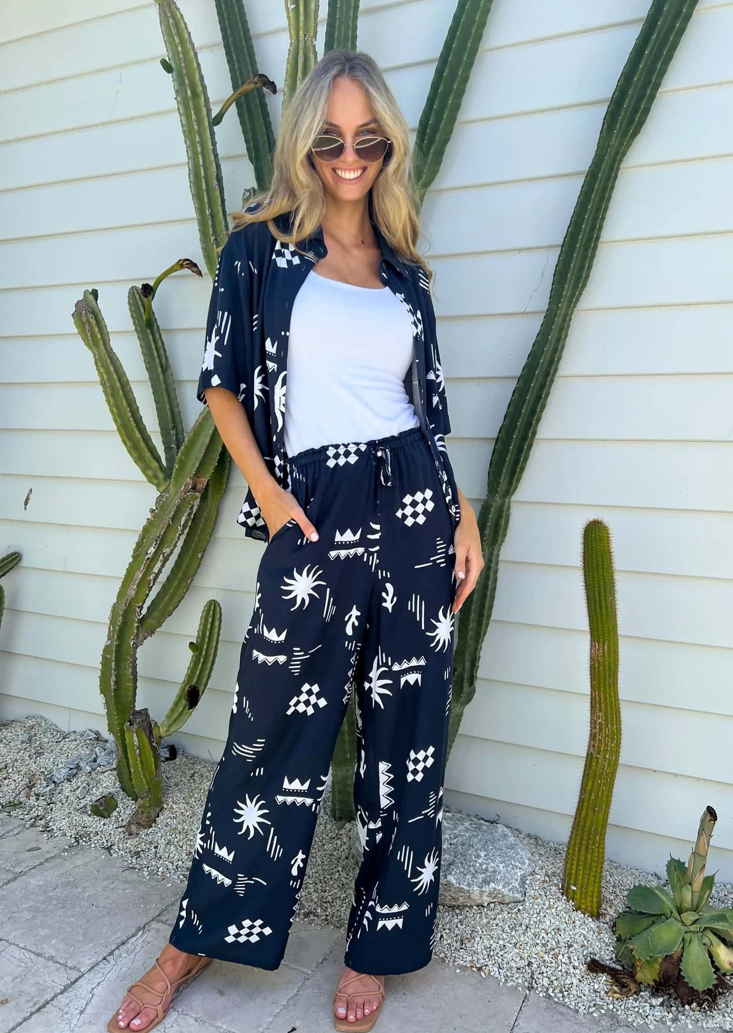 Get ready to rock in the Tanah Set, featuring an oversized top and elasticated drawstring waist for a comfortable fit. With functional buttons and pockets, this navy print set is perfect for any occasion. One size fits all. No need to stress about sizing! (We got you, girl!)