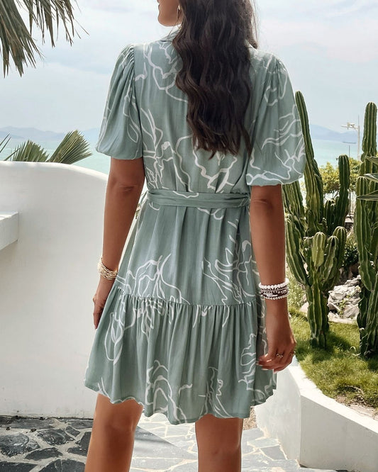 Show off your style in the Sophia Mini Dress! This dress will look great on any occasion thanks to its V neckline, collar detail, tiered style and tie-around closure. Plus, the button-down detail adds a fun and quirky look. Be ready to turn heads when you step out in this must-have dress!