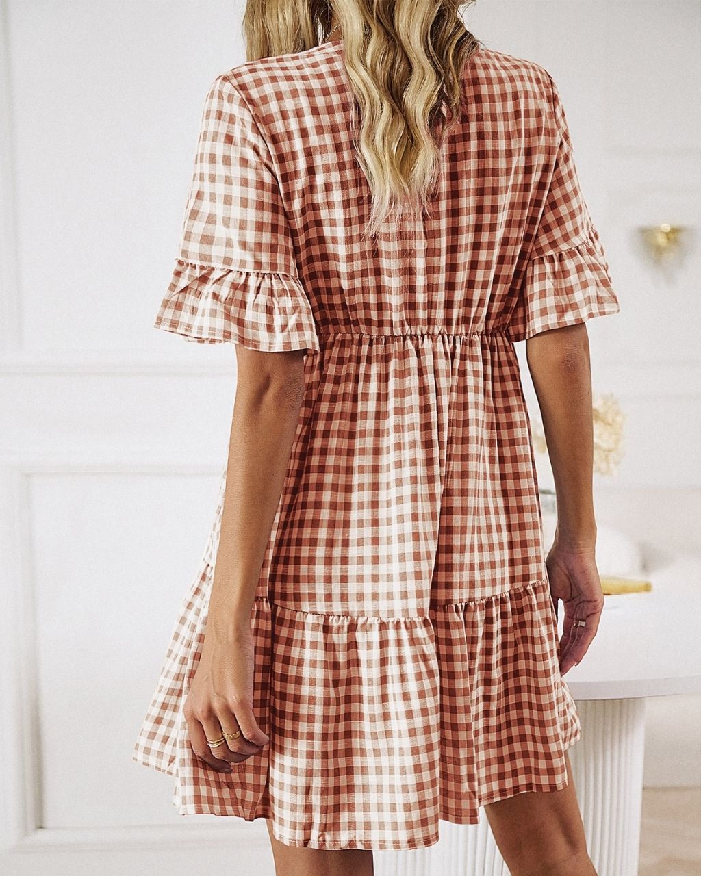 Get ready for an adventure in style with the Lucy Mini Gingham Dress! A fun rust color, and the all-over gingham print make it a must-have for your wardrobe. Not to mention the button detail, draw-up-string, tiered style and cap sleeves give it that extra special something! Ready, set, gingham style!