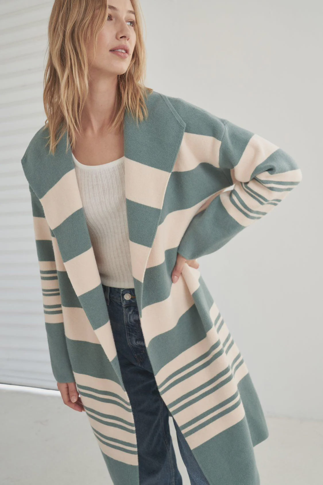 Introducing the Deia Coatigan, your new favorite piece for cozy-chic style. This green block stripe coatigan features a wide collar and full length sleeves for extra comfort and warmth. With a long length, the Deia is perfect for layering and staying stylish all season long.