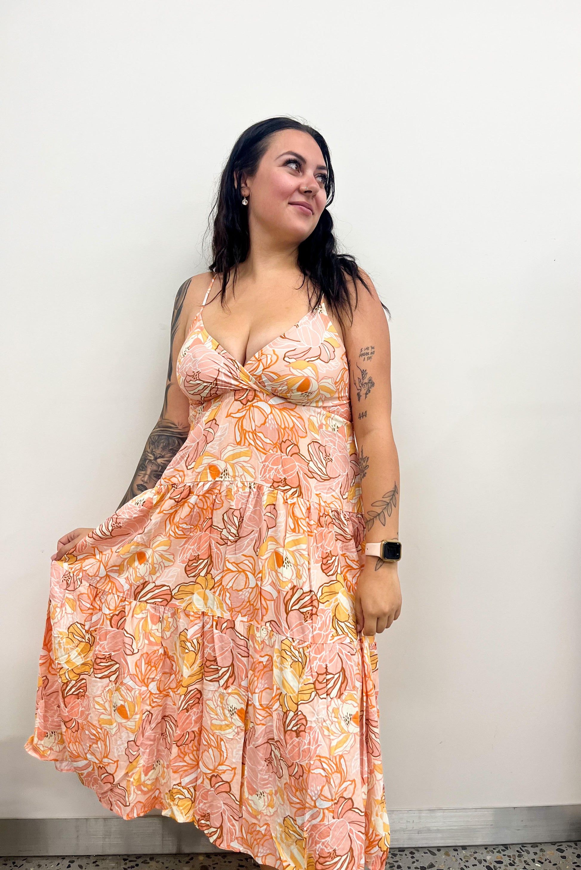 Introducing the Flower Power Midi Dress - the perfect combination of timeless elegance and modern sophistication. Featuring a V neckline, spaghetti straps, and a tiered style, this dress will add a touch of luxury to any ensemble.