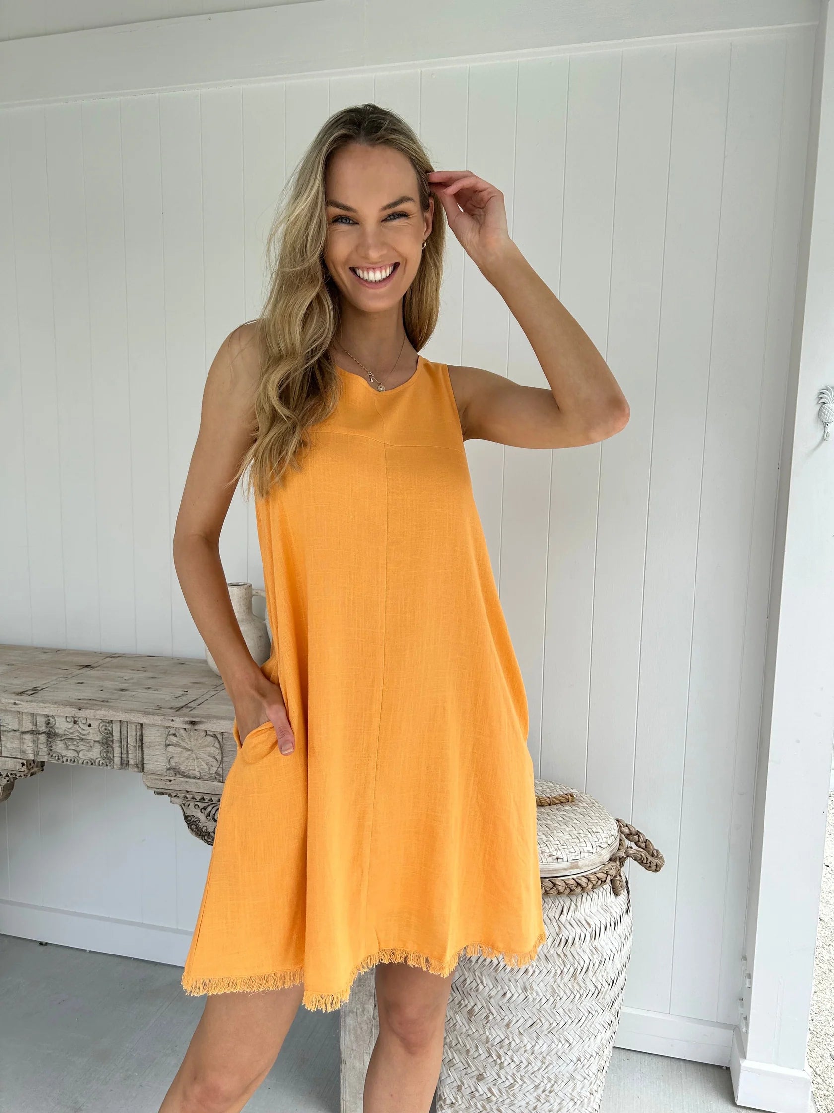 Be inspired by the beauty of nature with this Freya Mini Dress. Featuring a gorgeous earthy orange, a frayed hem, and pockets, this shift fit dress is both stylish and practical. Its lightweight fabric is fully lined to keep you feeling comfortable and looking chic all day long. Perfect for any occasion.
