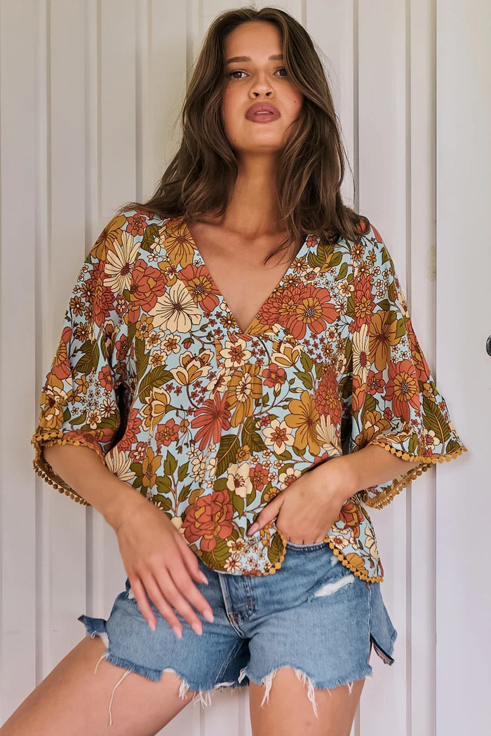 Introducing the enchanting Gabriella Top in the stunning Mimosa Print. A mesmerizing blend of bohemian elegance and contemporary style. The delicate crochet trim detailing evokes a sense of whimsy. Featuring a beautiful soft V-neckline. Pair it with your favourite denim shorts for a casual and carefree look, or dress it up with a flowing maxi skirt and strappy sandals..