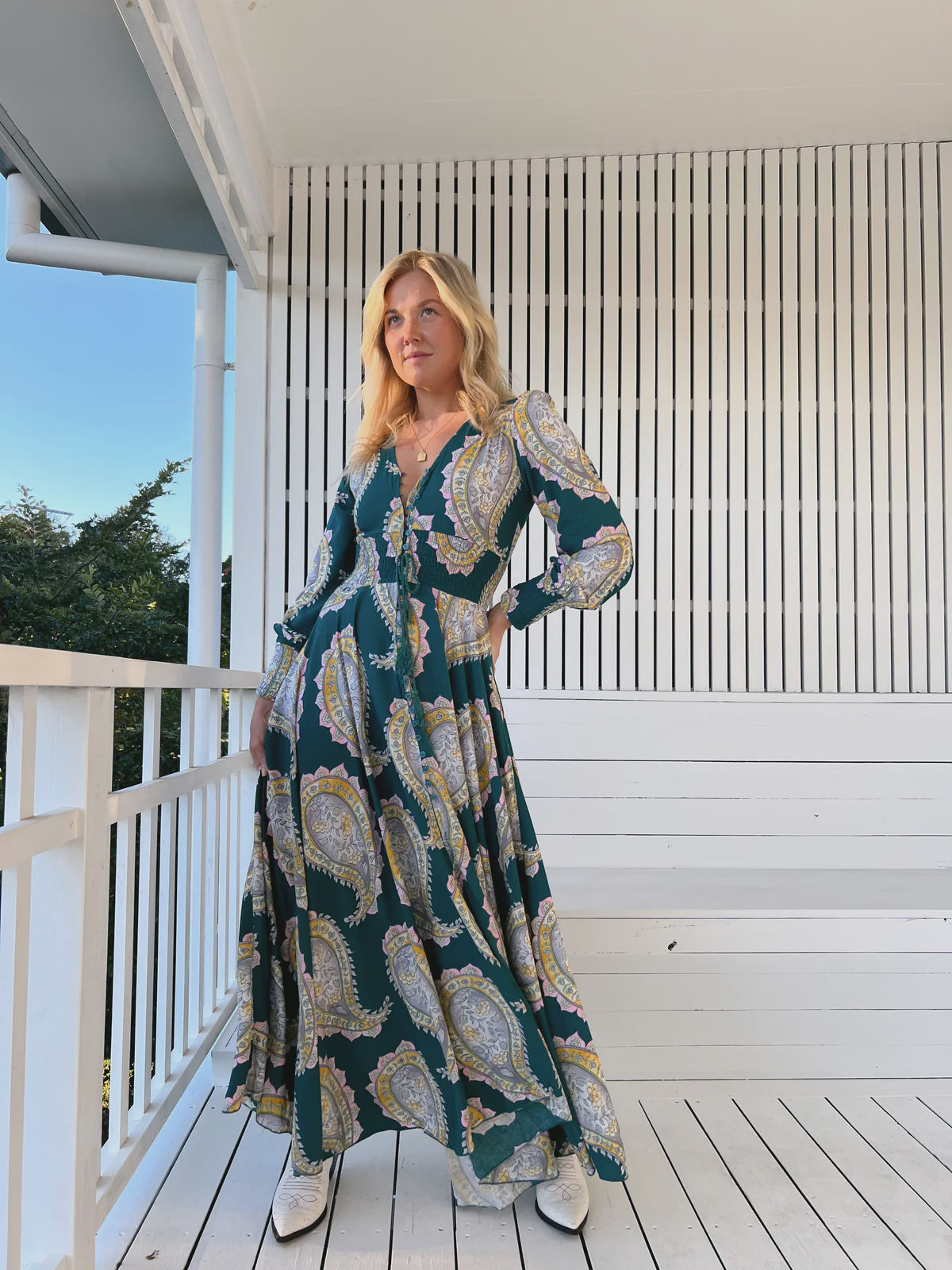 Unleash your free spirit with the Indie Maxi Mahala Print. This playful dress features a V neck line, button through design, and shirred cuffs for a bohemian vibe. The elastic waist ensures a comfortable and flattering fit. Embrace your inner quirkiness and stand out in this one-of-a-kind piece!