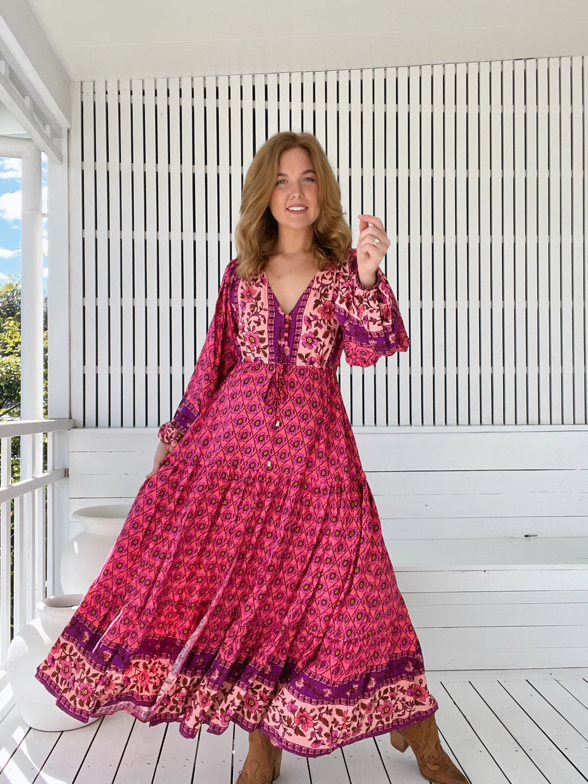 Unleash your inner boho babe with the Teresa Maxi dress in the captivating Jolene Print. The V neck-line and buttons down the bust add flirty details while the long billowy sleeves with cuffs add a touch of romance. Cinch your waist with the tie up feature for a figure-flattering silhouette.