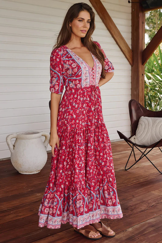 Unleash your bold style with the Tessa Maxi in Ruby Rouge Print. This playful dress features a V neckline and relaxed fit for comfort, while the drawstring waist and front split add a touch of flair. The button bodice and 3/4 sleeves with elasticated cuff complete this quirky and fun look. (Go ahead, turn heads!).
