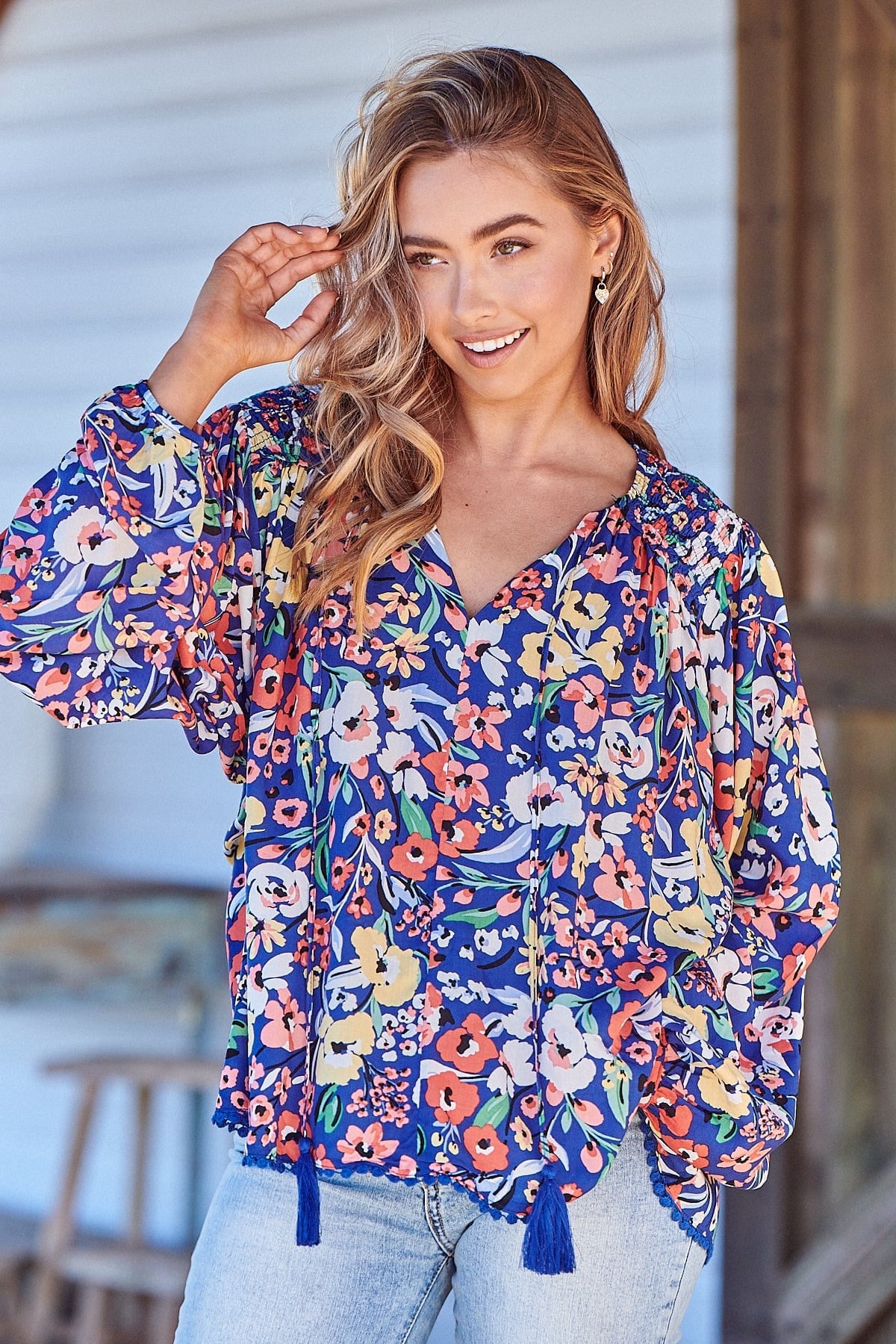 Introducing the Rue Top - Carnation Print. Rock the V-neckline and tassel ties while staying cozy in the oversized, long-sleeve design with cuff. Perfect for adding a touch of fun to any outfit!