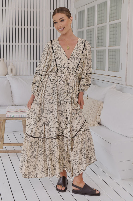 Indulge in the sophisticated elegance of Catalonia Maxi - Eliose Print. Adorned with hand-drawn flowers, this flowy maxi dress features a flattering V-neck, drawstring waist, and button-through bust. The piping details add a touch of luxury, making this dress perfect for any occasion. Embrace its chic and exclusive design and turn heads wherever you go.