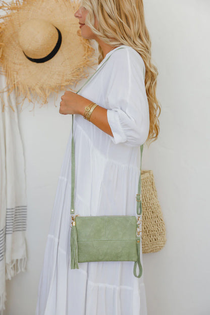 Get ready for some serious style with our Pistachio Clutch! With a long strap and wrist strap included, it's perfect for a night out. Keep your essentials organized with the lined inside and add some fun with the matching tassel. Don't just carry a bag, make a statement!