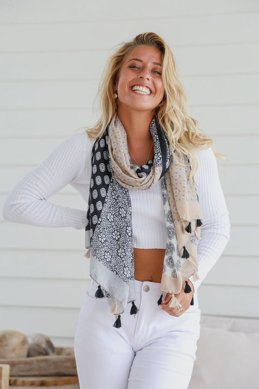 Wrap yourself in style with our Black and Natural Light Scarf! Featuring a lightweight design and playful tassel trim, this scarf is the perfect accessory for any outfit. Stay trendy and stay cozy with our versatile and fun scarf.