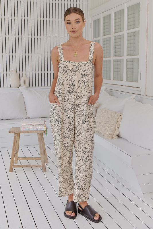 Introducing the Zandra Jumpsuit - Eliose Print. This pinafore style one-piece features shoulder straps with rings at the back, side pockets, and a slightly cropped hem. Elevate your style with the perfect blend of comfort and sophistication.