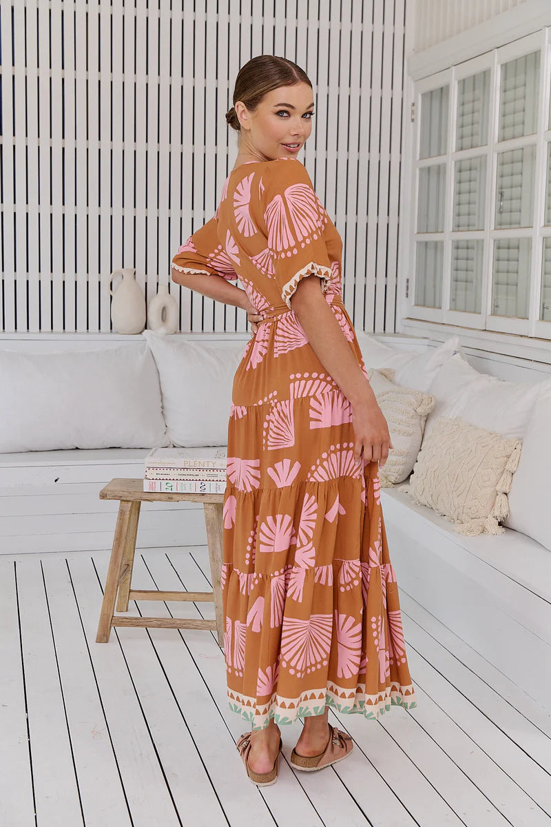 Introducing the Maddi Wrap Dress, a boho dream come true. This maxi dress embodies effortless elegance with its flattering V-neckline, wrap front and tie closure, and mid-length sleeves. Its full-length design effortlessly flows, making it the perfect choice for a chic and carefree look.