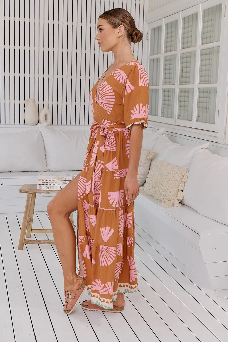 Introducing the Maddi Wrap Dress, a boho dream come true. This maxi dress embodies effortless elegance with its flattering V-neckline, wrap front and tie closure, and mid-length sleeves. Its full-length design effortlessly flows, making it the perfect choice for a chic and carefree look.