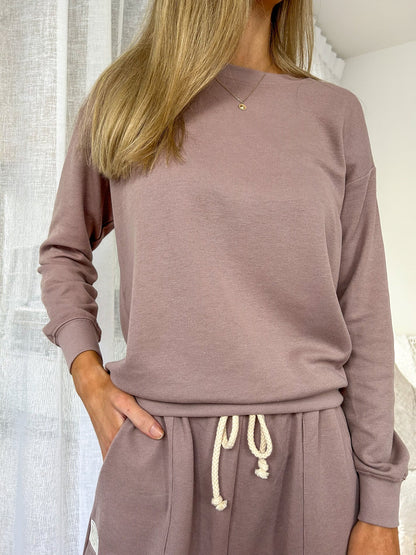 Cozy up in style with the Mylk Lounge Sweater! This long-sleeved, loose-fitting sweater features the signature Mylk logo, adding a touch of personality to your wardrobe. Perfect for lounging or running errands, this sweater will keep you comfortable and effortlessly cool.