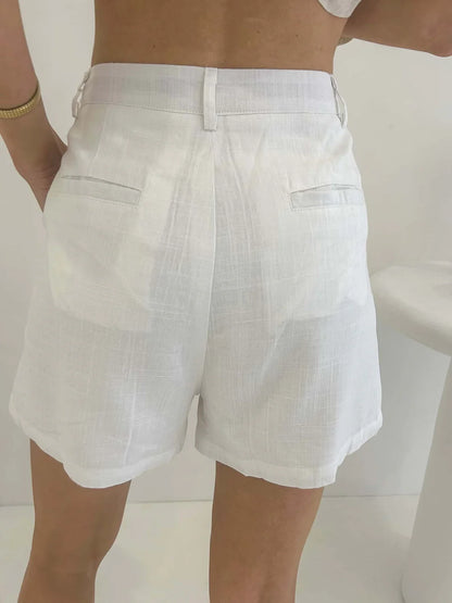 Elevate your summer wardrobe with these Amie Shorts in white. Crafted from luxurious, lined fabric, these shorts feature functional buttons and pockets for added convenience and style. Perfect for a day out in the sun or a night on the town.