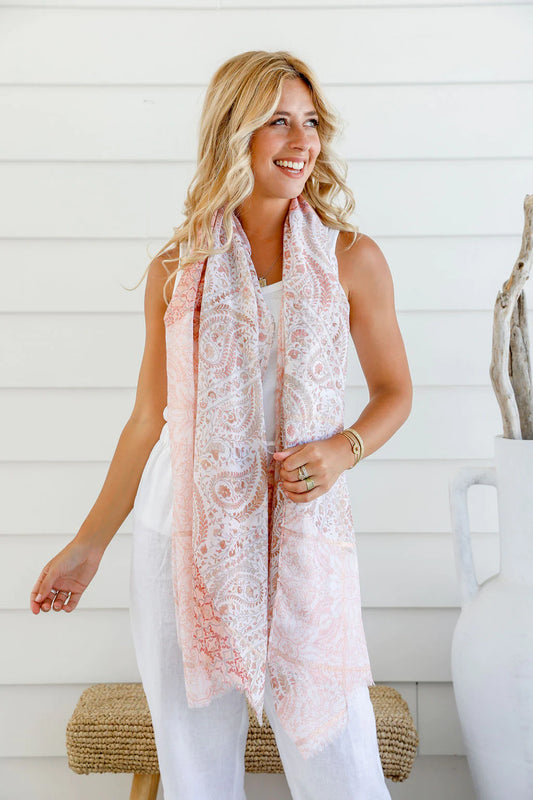 Add a touch of elegance to your look with our Blush Paisley Pink Light Scarf. This lightweight scarf features a delicate frayed trim and subtle blush glitter detail, perfect for adding a touch of sophistication to any outfit. Stay stylish and comfortable with this must-have accessory.