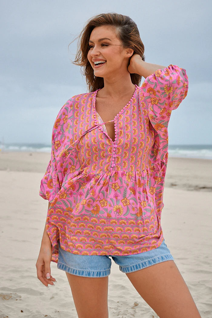 Be effortlessly chic in our Chloe Top - Rosewater Print! This oversized top features delicate crochet trimming around the neckline for a touch of bohemian charm. With functional buttons and a neckline tie, this top offers both style and practicality. The v-neckline adds a flattering touch.
