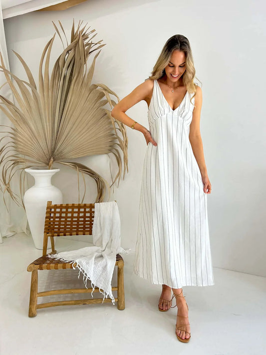 Indulge in the luxurious charm of our Matilda Tie Dress. Featuring an elegant monochrome stripe design, this fully lined dress is crafted from a premium linen and cotton blend. The adjustable tie shoulder straps add a touch of sophistication to this sophisticated and exclusive piece. Elevate your style with this timeless dress.