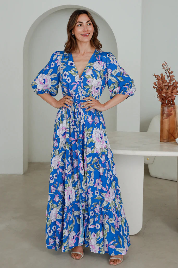 Step out in style this season with the Hattie Maxi Dress. Layer this elegant dress over any look and enjoy the comfort and versatility of its features. With a drawstring waist, V-neckline, and button details, you'll enjoy the slimming silhouette, while split at the leg and elasticated long-sleeved cuff allows for an effortless transition from day to night.