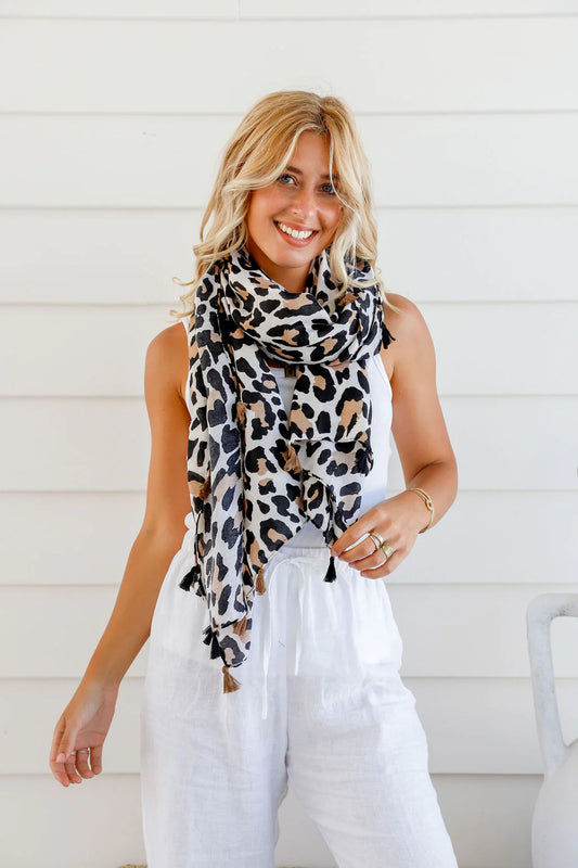 Take a walk on the wild side with our Animal Print Natural Light Scarf! Made with a lightweight material and accented with playful tassels, this scarf is perfect for adding a touch of adventure to any outfit. The perfect accessory for those who like to take risks and make a bold statement!