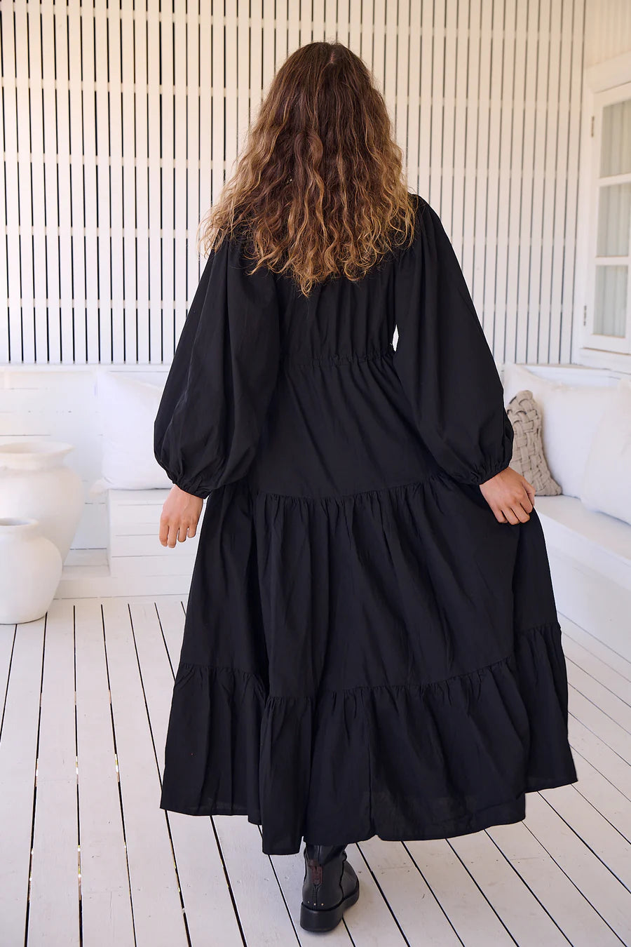 Unleash your inner goddess in the Teresa Maxi dress! With a sleek v-neckline and billowy sleeves, this dress is both elegant and comfortable. The button down bust adds a touch of whimsy, while the tie-up waist cinches your waist for a flattering silhouette. Available in versatile Onyx, this dress is perfect for any occasion.(Goddess-worthy!)