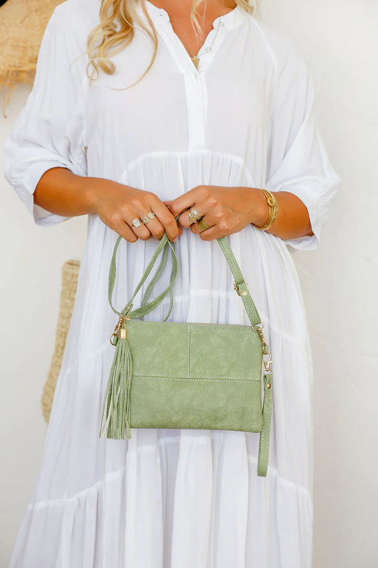 Get ready for some serious style with our Pistachio Clutch! With a long strap and wrist strap included, it's perfect for a night out. Keep your essentials organized with the lined inside and add some fun with the matching tassel. Don't just carry a bag, make a statement!