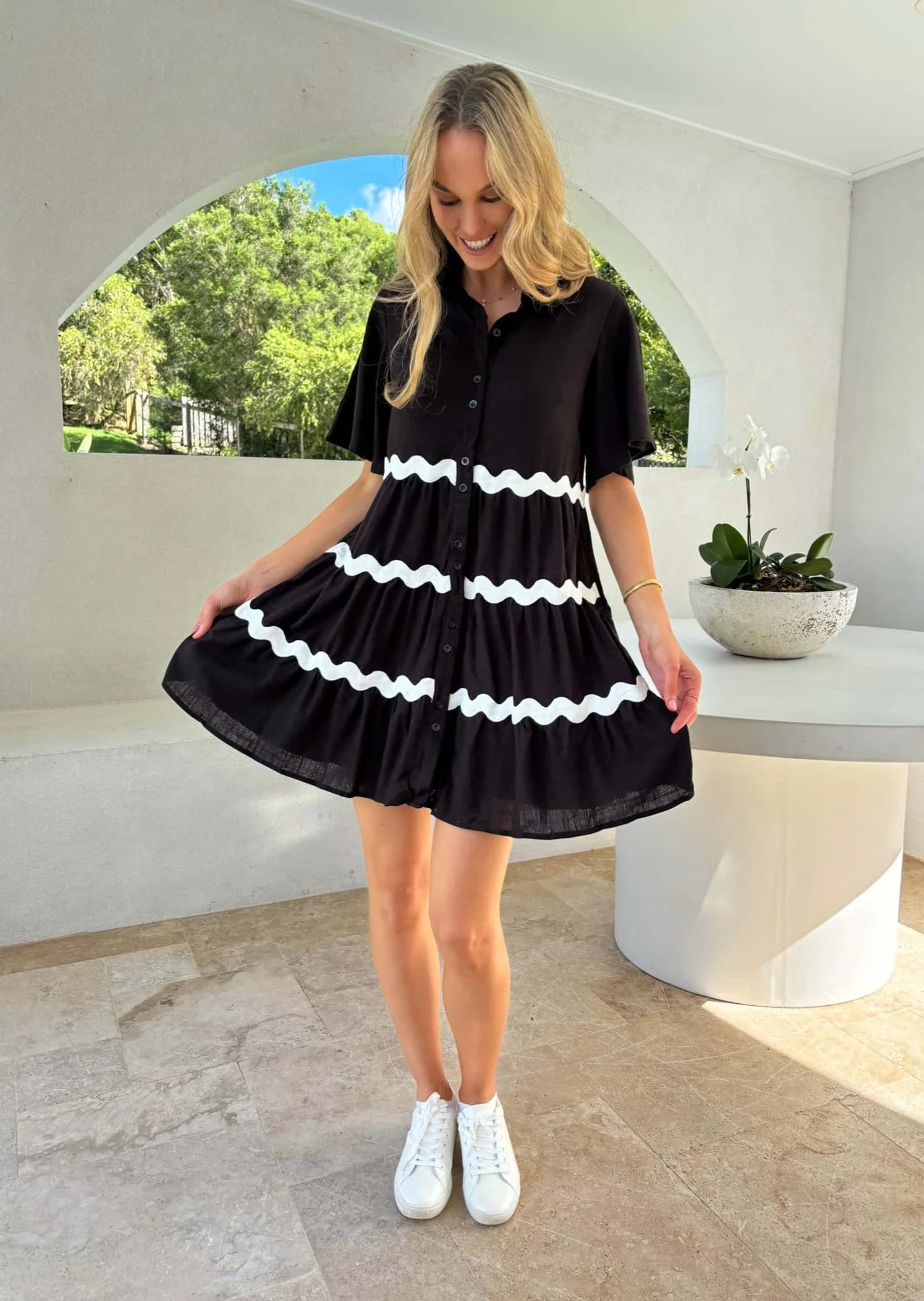 Unleash your playful side with the Kesha Ric Rac Dress. Featuring fun and quirky Ric Rac detailing, functional buttons, and convenient pockets, this mini length shift style dress is perfect for a day of fun and adventure. Add a touch of whimsy to your wardrobe with this black dress. (Get ready to turn heads with your unique style!)