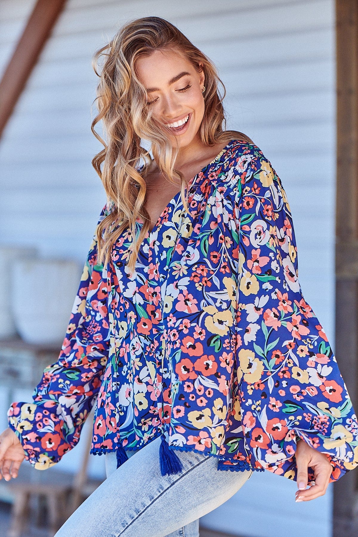 Introducing the Rue Top - Carnation Print. Rock the V-neckline and tassel ties while staying cozy in the oversized, long-sleeve design with cuff. Perfect for adding a touch of fun to any outfit!