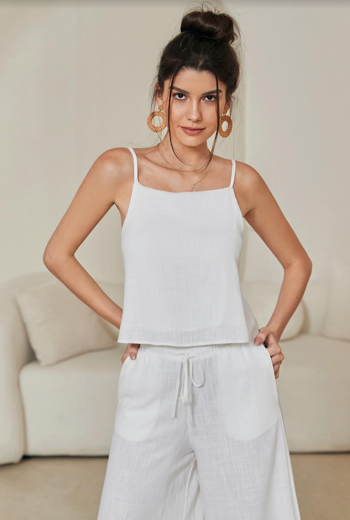 Discover effortless luxury with the Tara Linen Crop Top. Boasting gold-plated details, a tie-up back, a cropped length, and delicate spaghetti straps, this sophisticated piece is both timeless and eye-catching. The lined design ensures a comfortable fit, perfect for any special occasion.