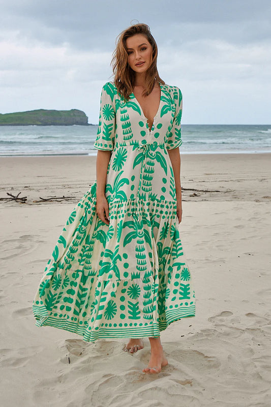 The Tessa Maxi - Nazare Print dress boasts a flattering V neckline and relaxed fit, making it comfy for all-day wear. The drawstring waist cinches in for a customizable fit, while the front split and button bodice add a touch of elegance. With 3/4 sleeves and an elasticated cuff, this dress is both stylish and practical.
