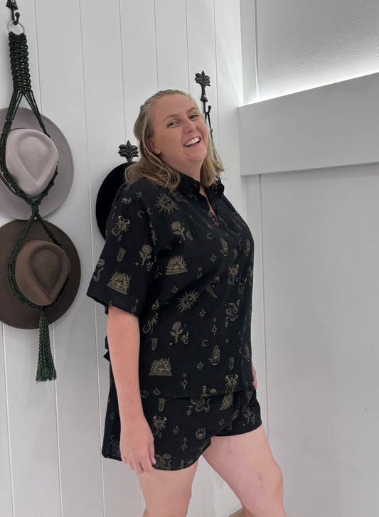 Be ready to rock in these edgy Black/Tan Scorpion Set. With the elasticized shorts for a perfect fit, lined shorts for comfort, and a tie-up collar with button detail for style. These will surely make a statement with a playful and quirky touch. Who knew scorpions could be this fun?!