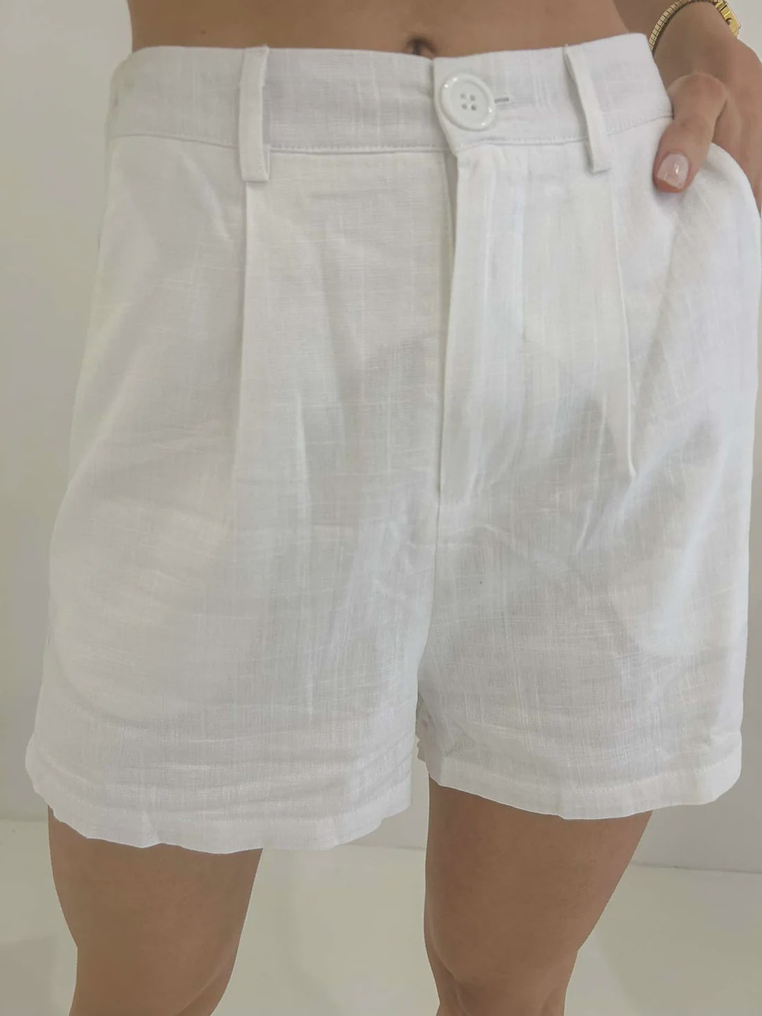 Elevate your summer wardrobe with these Amie Shorts in white. Crafted from luxurious, lined fabric, these shorts feature functional buttons and pockets for added convenience and style. Perfect for a day out in the sun or a night on the town.