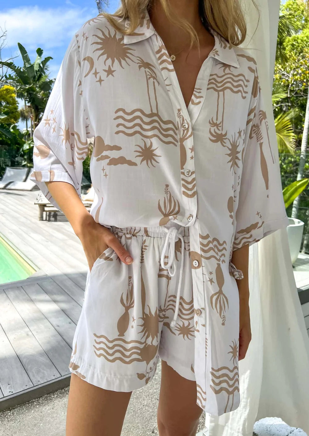 Overlook the shores of neutral Maldives in the Aria Set! This oversized top with functional buttons and lined pants feature an elasticated and drawstring waist with contrast rope detail for the chicest ensemble. From beach-hangouts to island-hopping, this is a must-have look!
