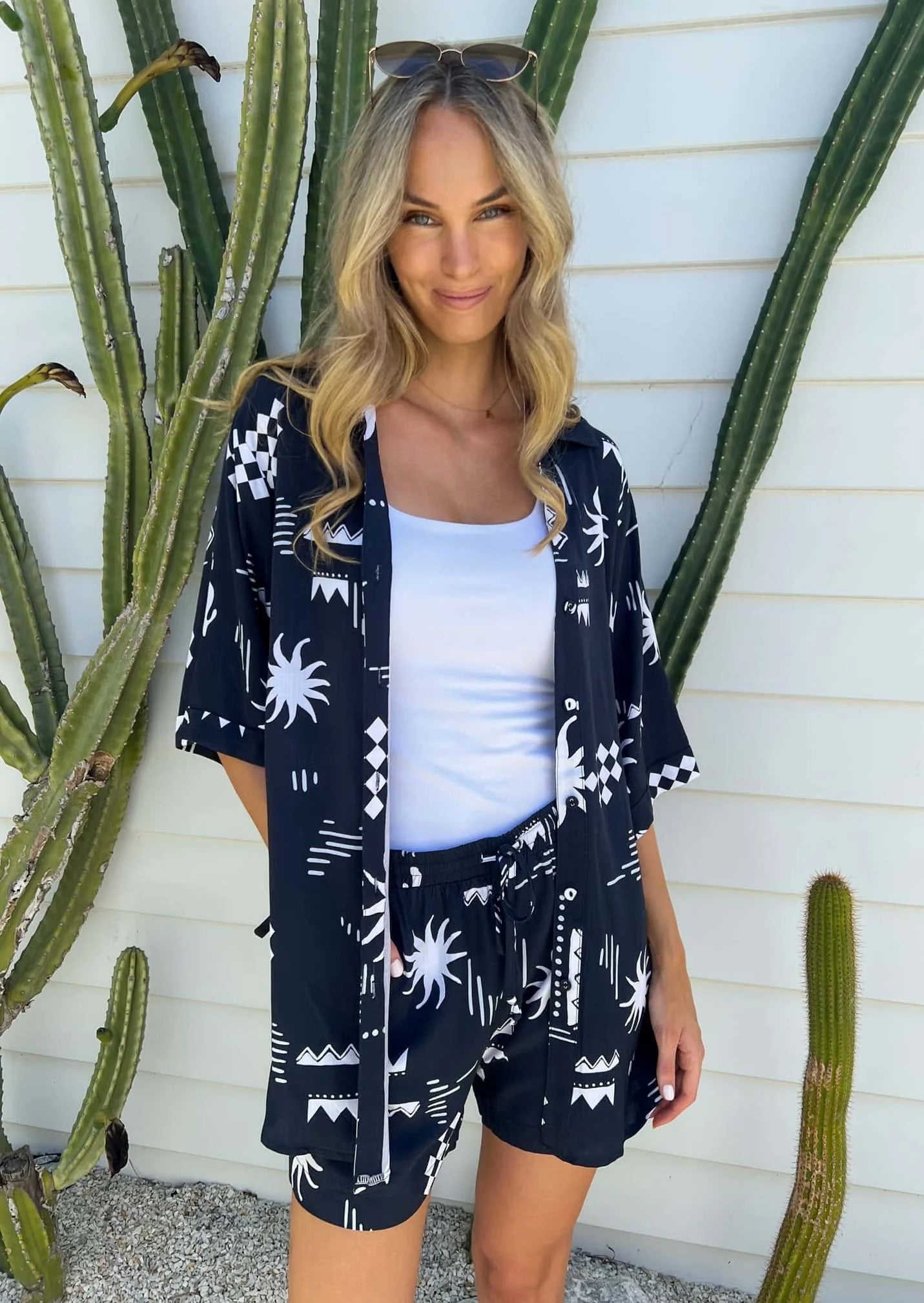 Stay cool and stylish with the Aria Set in Sol Navy Print! This set features an oversized top for ultimate comfort, functional buttons for easy wear, and a lined short with an elasticated and drawstring waist for the perfect fit. Don't forget the cute contrast rope drawstring for a touch of fun!