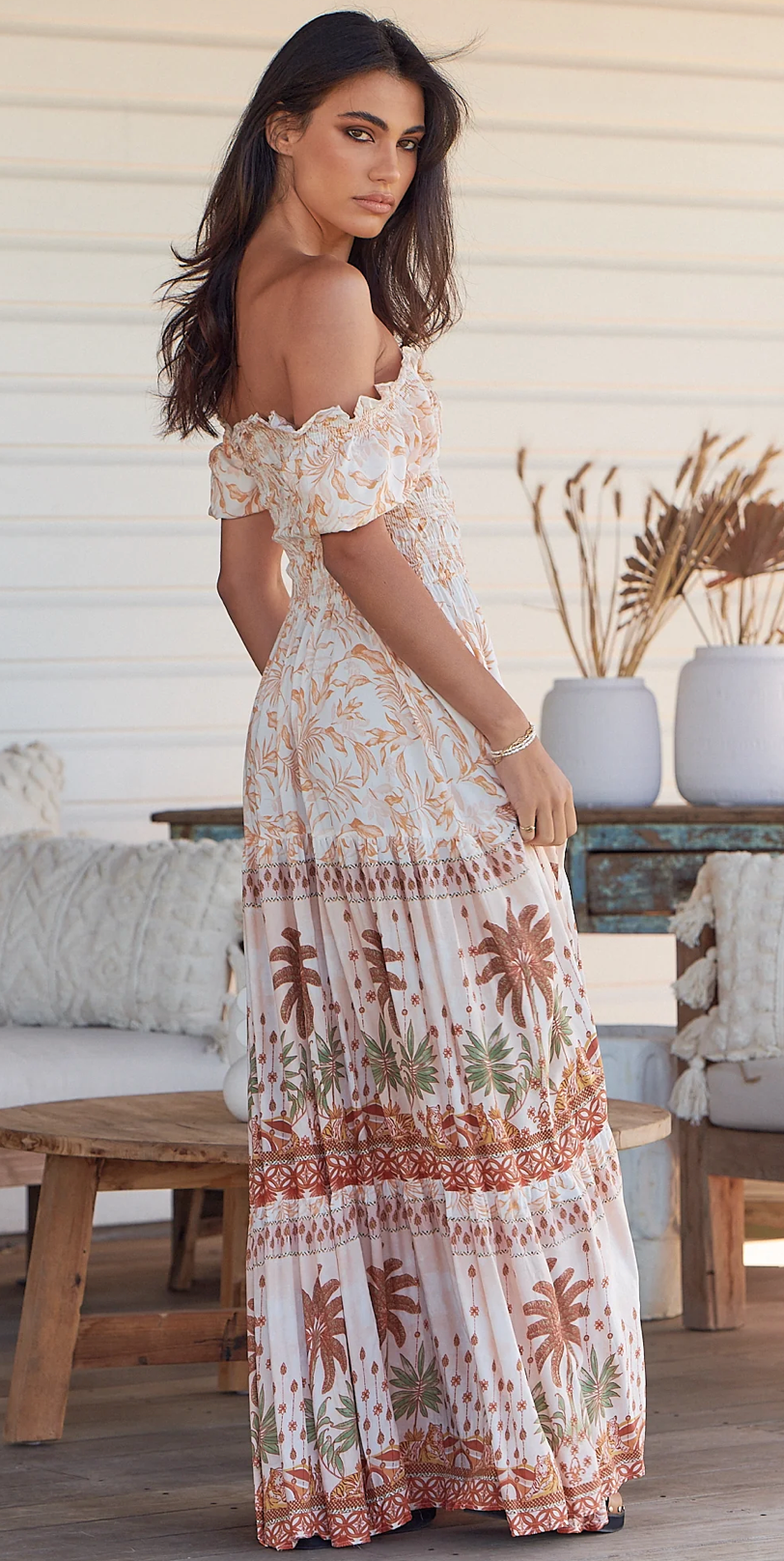 Unleash your inner flower child with the Claudette Maxi Dress in Yasmina! This flowy and floral off-the-shoulder dress is perfect for a bohemian-inspired look. The elastic cuffs offer a comfortable fit while the maxi length adds a touch of elegance. Perfect for any summer event. (No flower crown necessary.)
