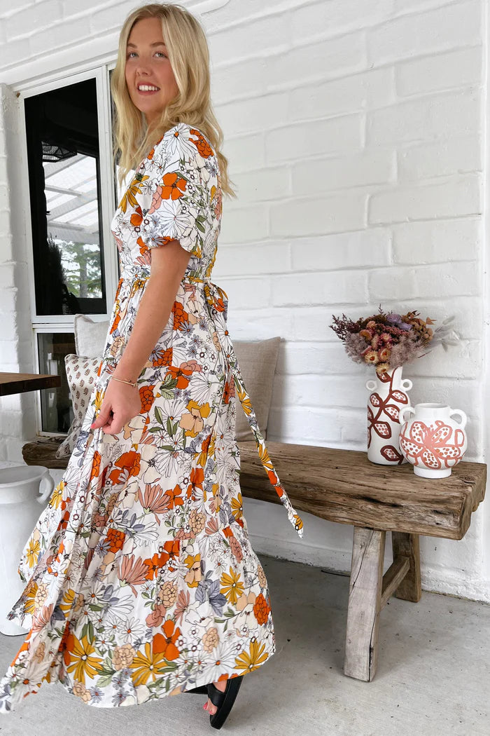 "Get ready to turn heads in the playful Maddi Wrap Dress featuring a daring V neckline, wrap around style, and tie up at the front for a flirty touch. Complete with cuff sleeves, this dress is perfect for any occasion!"