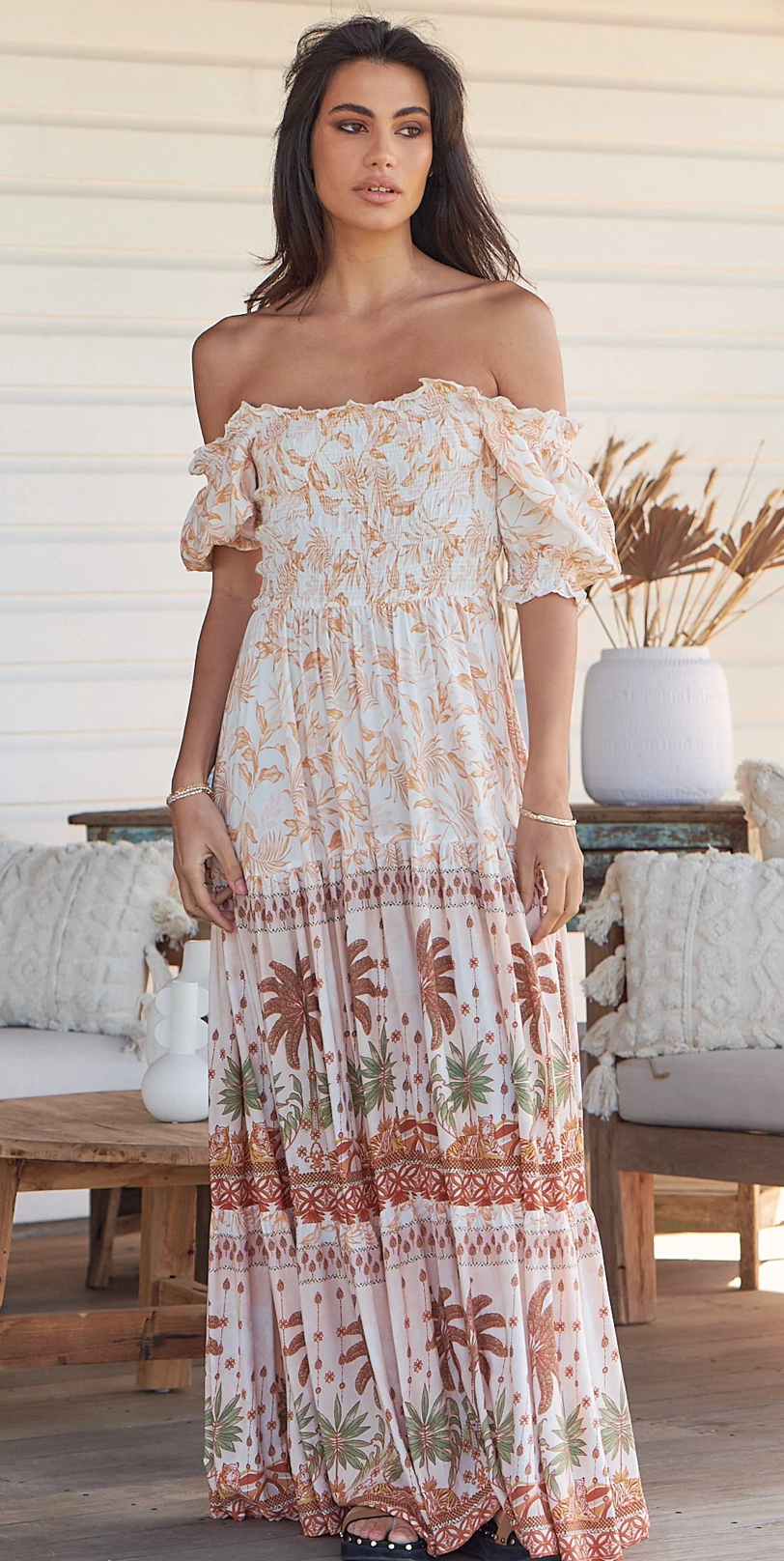 Unleash your inner flower child with the Claudette Maxi Dress in Yasmina! This flowy and floral off-the-shoulder dress is perfect for a bohemian-inspired look. The elastic cuffs offer a comfortable fit while the maxi length adds a touch of elegance. Perfect for any summer event. (No flower crown necessary.)