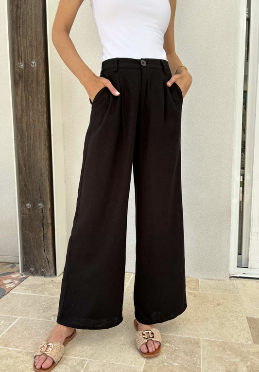 Indulge in sophistication with our Dasha Linen Pants in classic black. These premium pants feature a lined design, convenient pockets, and stylish belt loops. The zipper and elasticated back waist provide both comfort and style. Elevate your wardrobe with these luxurious linen pants.