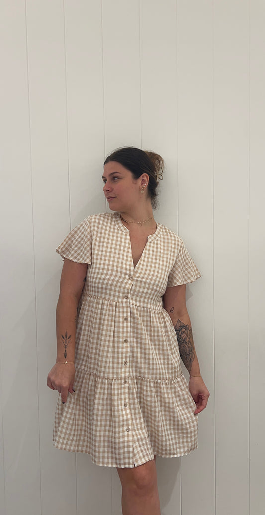 Step out in style with the Annabelle Mini Dress Gingham! This playful mini dress features a v-neckline and a tiered style for a flirty and feminine look. The cute button details add a touch of whimsy, making it the perfect choice for a day out with friends or a casual date night. Get ready to turn heads with this unique and charming dress!
