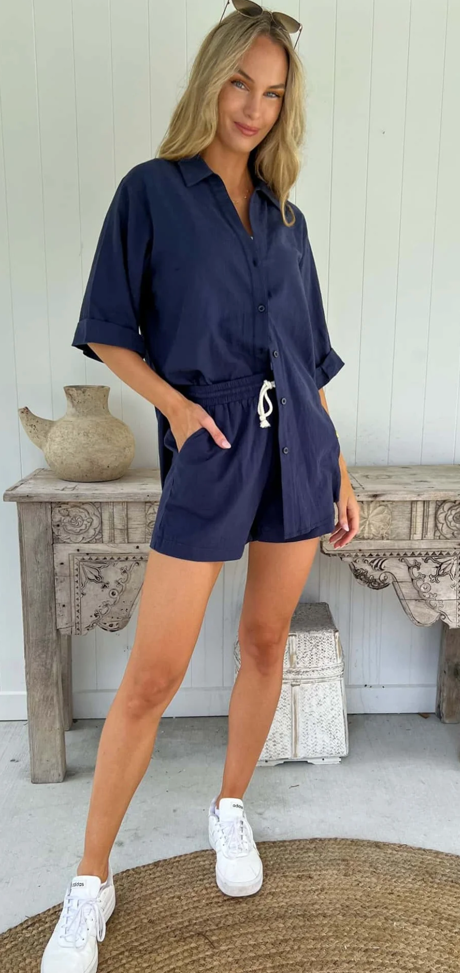 Introducing the Aria Set - Navy! This playful set features a functional top with easy, one size fits all design and functional buttons. The top also boasts a charming tie detail, while the elasticated shorts provide the perfect fit for any body type. Get ready to rock this effortlessly chic look!