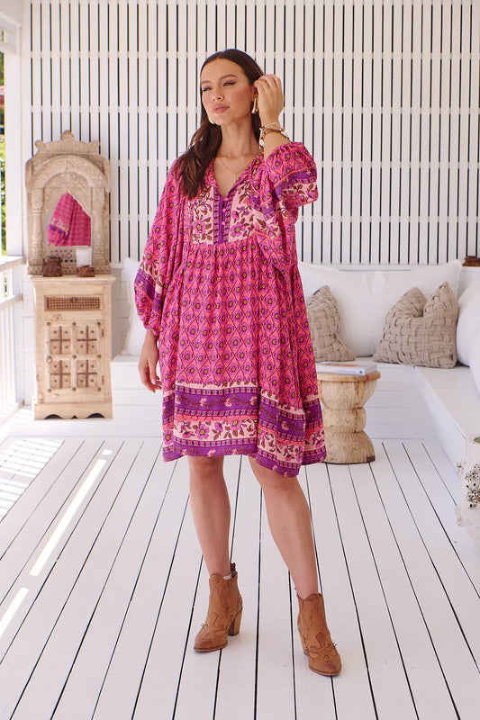 Get ready to turn heads in the Adela Midi Dress! This colorful and playful dress features delicate lace detailing on the bust and sleeves, as well as a unique border splicing design. The V-neckline and ballon sleeves add a touch of elegance, while the front pockets and oversized style provide both functionality and style. Rock this dress with its border print and mid-thigh mini length for a fun and flirty look!