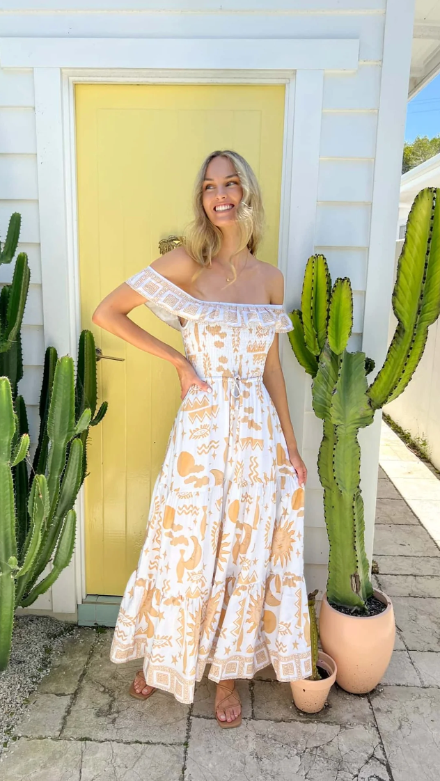 Get ready to turn heads in the Rylan Maxi dress! With a playful off-shoulder style and flirty bust frill detail, this maxi dress is perfect for any occasion. The rouched bust and tie waist add a flattering touch, while the Mekka print adds a unique and quirky flair. Stand out in style and comfort with this must-have dress!